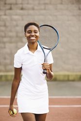 Young women with a racket in a tennis court