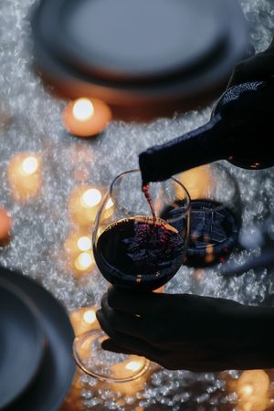 Overview of wine being poured at romantic holiday table
