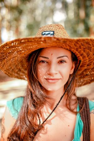 Smiling woman wearing brown straw hat