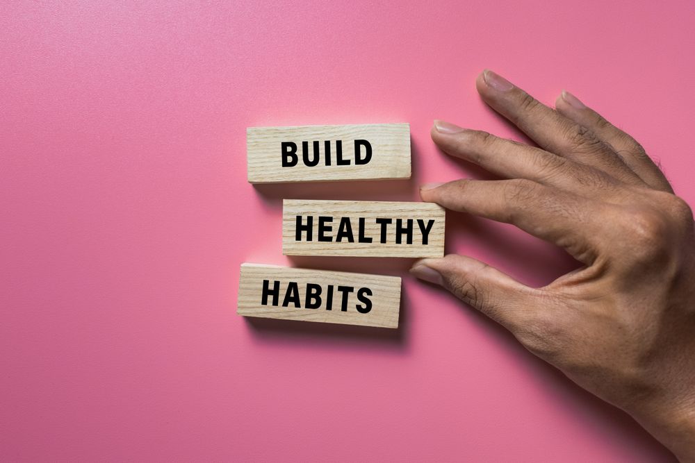build good habits words symbol on wooden blocks isolated on pink background. motivational words concept