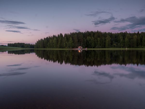 Sunset cabin landscape with river and forest