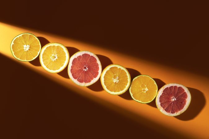 Halved citrus fruits in a line of sunlight