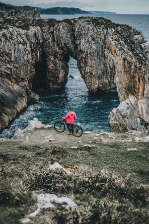 Female bicyclist on rocks