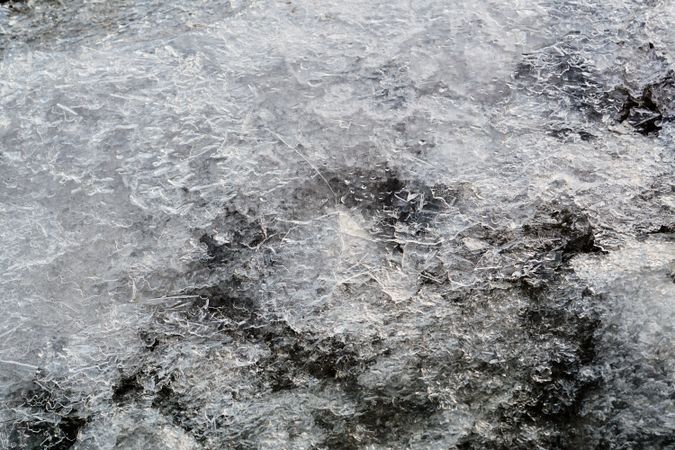 Melted snow crust over rocks