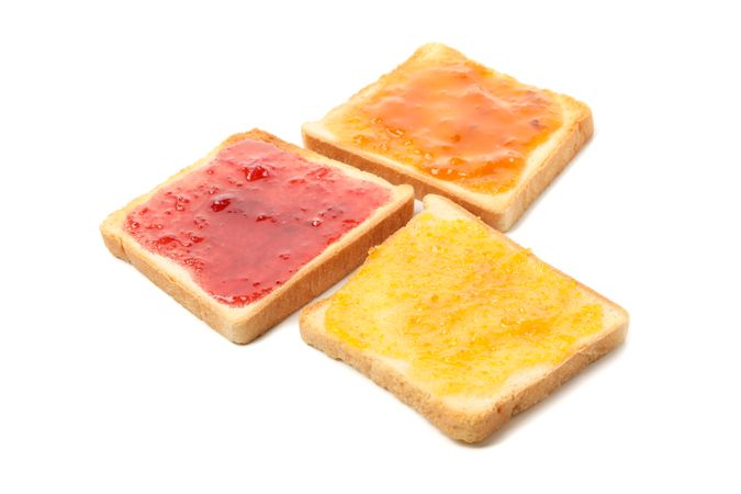 Toasts with jam isolated on plain background