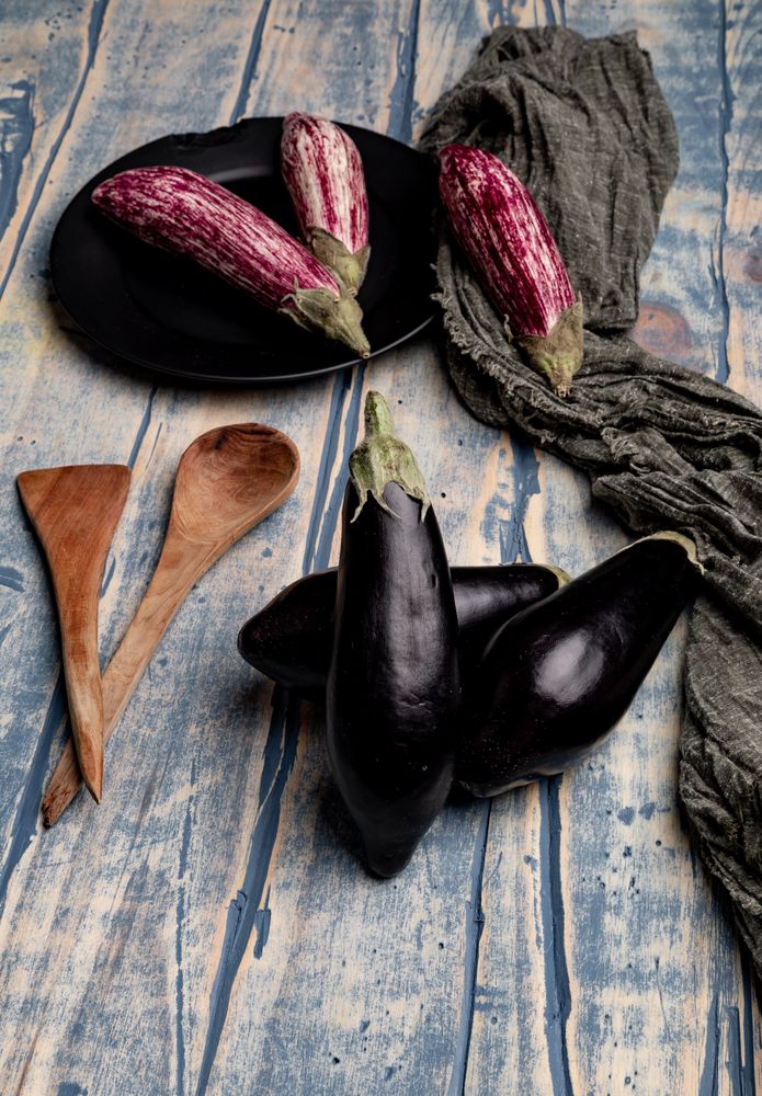 Ripe eggplants on shabby tabletop