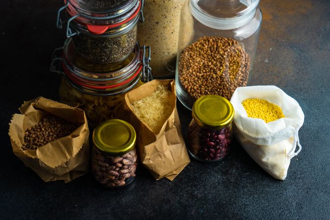 Selection of dried legumes and grains from pantry with copy space