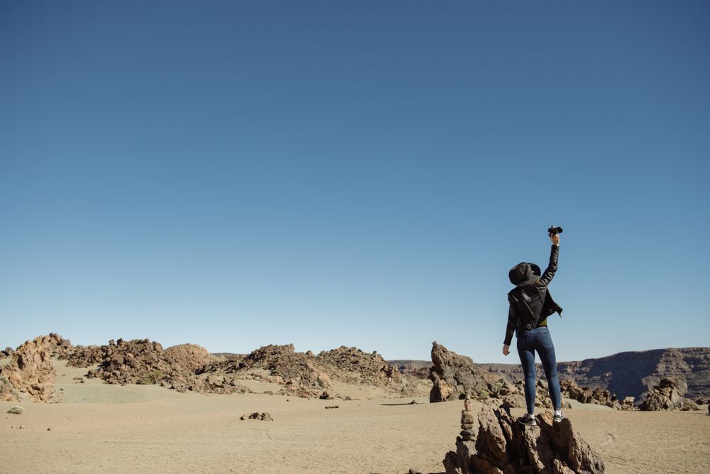 Tourist standing on top of rock