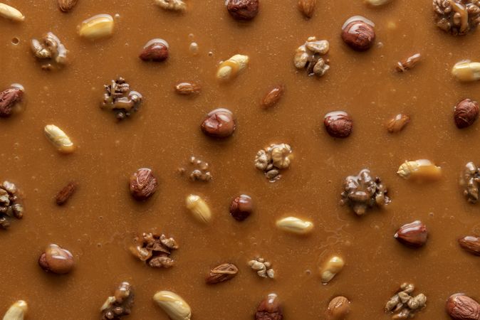 Caramel sauce and nuts background