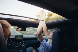 Young couple travels in convertible car during summer vacation