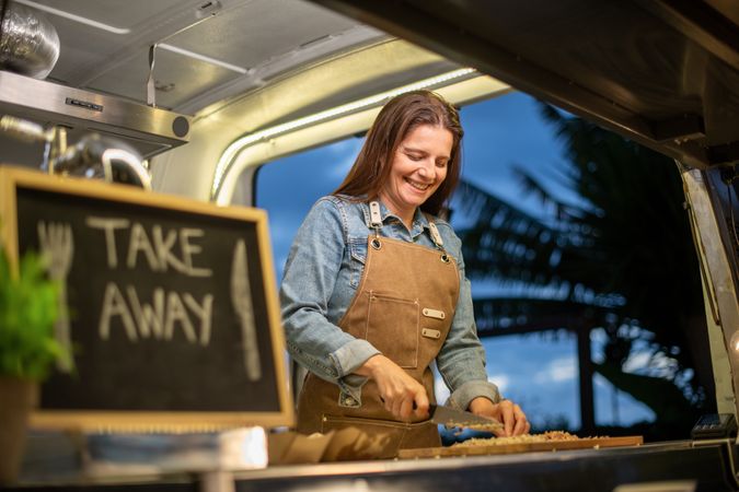 Happy woman with chalkboard in van