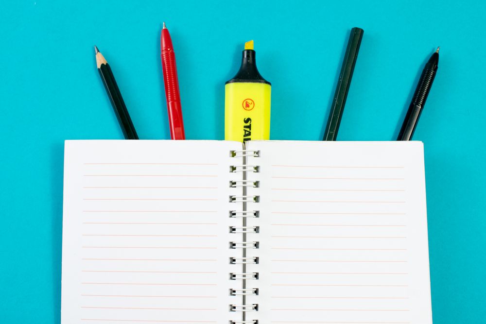 Open notebook with writing tools or school equipment