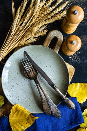 Top view of grey tableware with autumnal decor