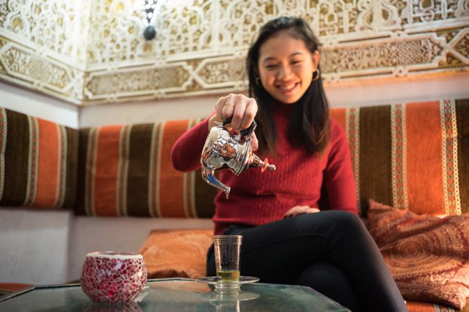 Asian woman enjoying Arabic tea