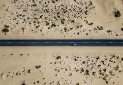 Car driving on road in picturesque desert