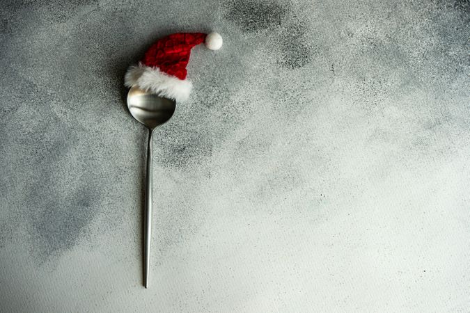 Christmas table setting with Santa hat on spoon