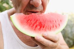 Older Man Enjoying a Watermelon.