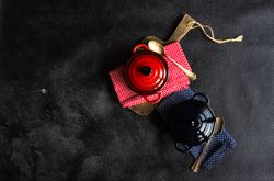 Top view of two red & blue cast iron pan on kitchen towels with copy space