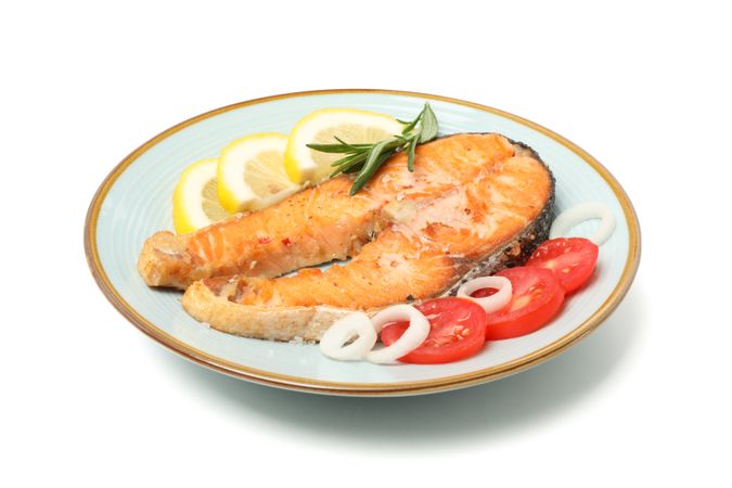 Plate with grilled salmon isolated on blank background