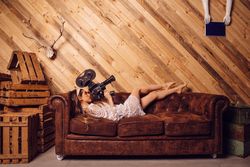 Young woman recording video with a vintage camera