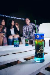 Cocktail glass on pallets table at an outdoors party