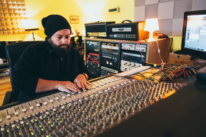 Man in a equalizer instrument in a studio