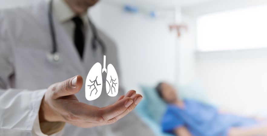 Doctor holds lungs icon for awareness
