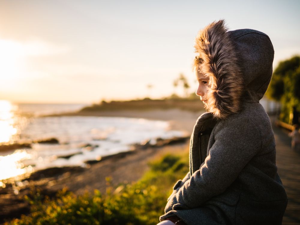 pensive girl at beach on winter
