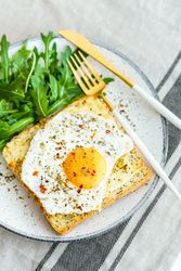 Delicious breakfast of fried eggs with toast and salad.