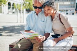 Older couple looking for destination on a city map 5rzBl5