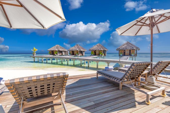 Beach resort looking out to the ocean with cabanas, parasols and reclining chairs