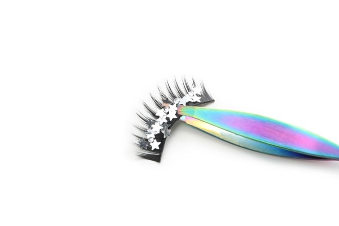 Concept of cosmetology tools, false eyelashes, isolated on light background