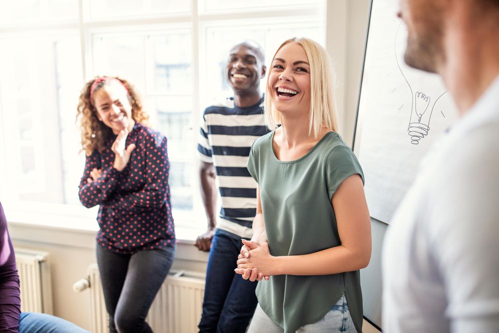 Group of people smiling during a presentation