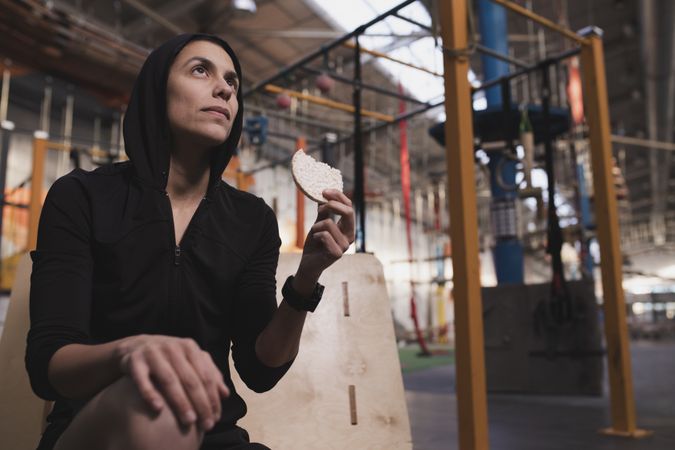 Smiling woman with rice cakes in gym