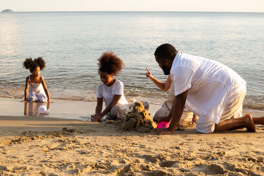 Black family building sand castle