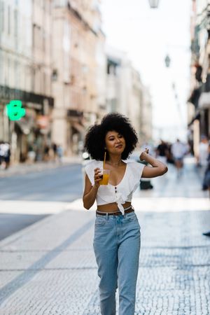 Young Black female enjoying refreshing drink