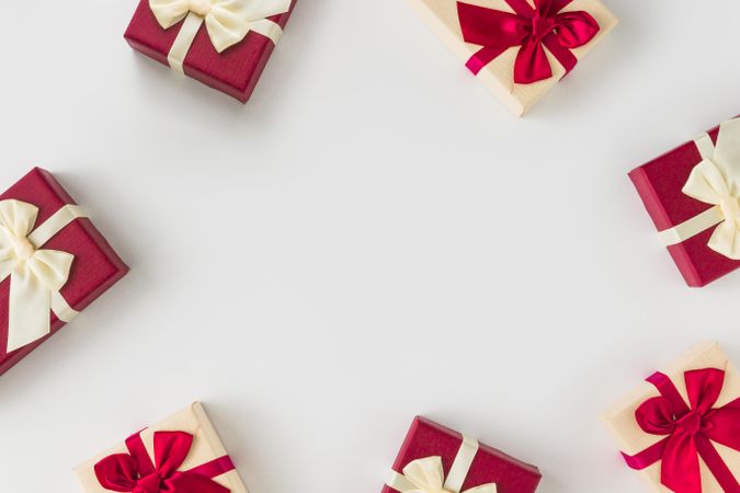 Red gift boxes wrapped in ribbon on light background