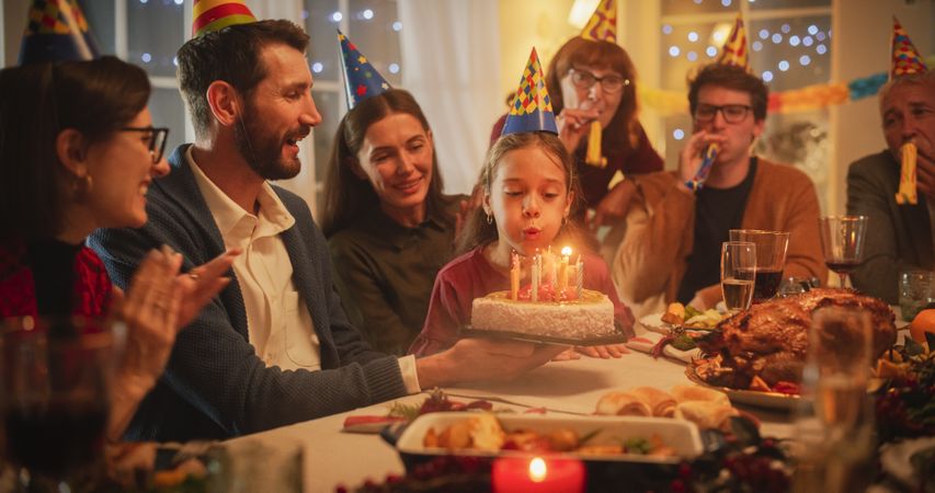 Family Celebrating Birthday with a Young Girl.