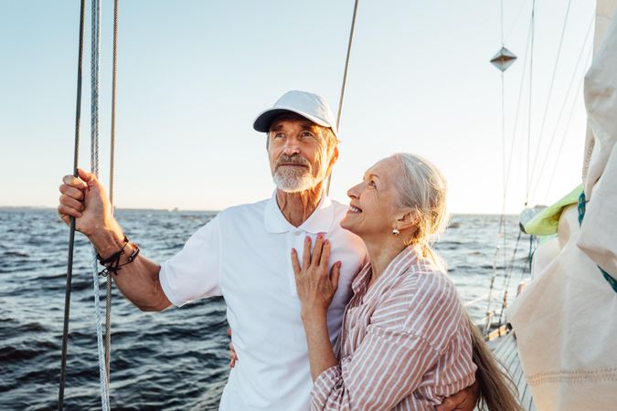 Happy couple with women embracing man on a boat