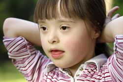 Close up portrait of little girl with her hands behind her neck