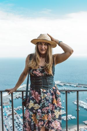 Stylish woman on terrace of seashore