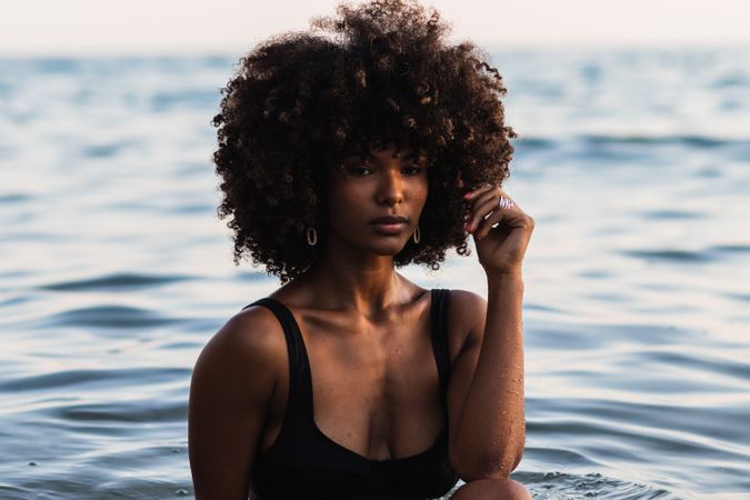 Calm Black woman in bikini in sea