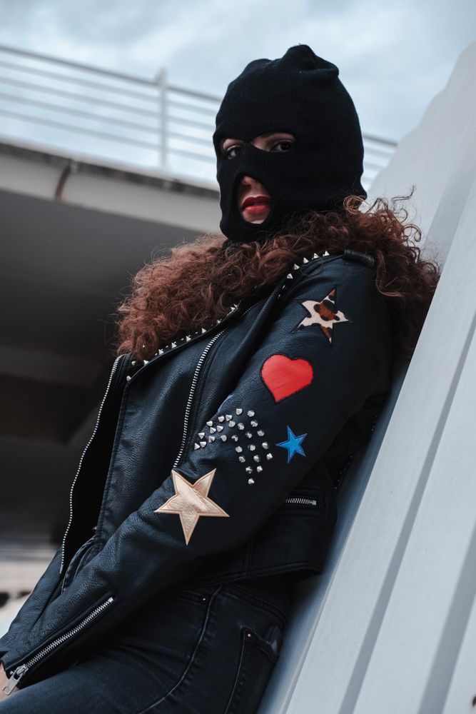 Woman in balaclava and leather jacket