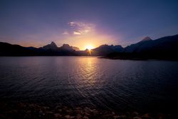 Wonderful lake between hills and blue sky at sunset
