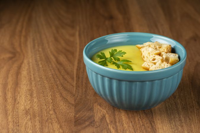 Bowl with onion soup and croutons on the table.