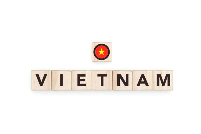 Wooden blocks bearing the name and flag of Vietnam. Vietnam Vietnamese and Asian Culture, national identity, travel, and geography in a copy space design.