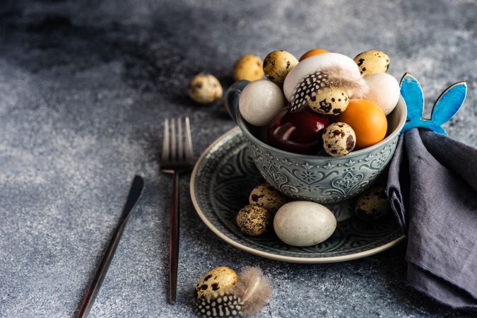 Easter table setting with bowls of different sized eggs with space for text
