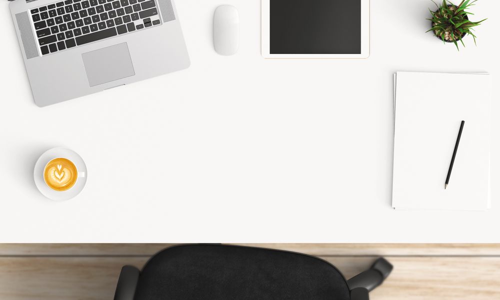Modern workplace with coffee cup and smartphone or laptop copy space on office table background. Top view. Flat lay style