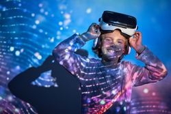 Cheerful child taking off VR headset and smiling at camera