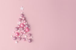 Christmas tree made of pink, purple and shiny glitter ball decoration on pink